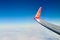 Airplane wing with coat of arms of Ukraine over clouds aerial top view from aircraft window