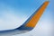 Airplane wing detail on blue sky background aerial