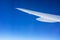 Airplane wing isolated on a graduated blue sky
