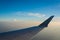 Airplane Wing over Blue Daytime Clouds