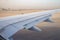 Airplane wing on the runway at ben gurion airport on sunrise