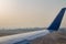 Airplane wing on the runway at ben gurion airport on sunrise