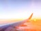 Airplane wing in the sky at beautiful sunset, airplane flight in the sky with copy space