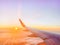 Airplane wing in the sky at beautiful sunset, airplane flight in the sky with copy space