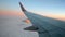 airplane wing in the sky during sunrise, aerial worldwide travel, environment,