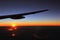 Airplane wing with warn and cold colors sky, beautiful sunrise light