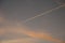 Airplanes and contrails of another airplanes at sunset.