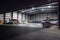 Airplanes parked inside a hanger with a door open at an Airport.