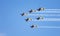 Airplanes performing acrobatic flight on blue sky. Trace of Smoke behind