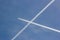 Airplanes and vapor trails forming a cross in the blue sky