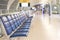 Airport blur background for air transportation travel concept with blurry bench seats for traveller or tourist on corridor