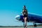 Airport and charming stewardess on blue airplane background. Portrait of charming stewardess wearing in blue uniform