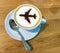 Airport coffee cup. Hot espresso on table, view from above. Airplane shape on top