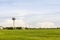 Airport control tower for air traffic management with at green field near oil tank on cloudy sky background in evening