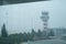 Airport control tower at Izmir Adnan Menderes Airport in a foggy weather