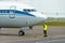 An airport employee in special clothes and headphones conducts pre-flight testing of the aircraft. The plane is on the runway. The