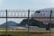 Airport fence and air plane behind