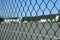 Airport fence closeup photo with blurred aircrafts