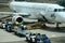 Airport ground support staff loading Luggage, suitcases and cargo into the aircraft hold