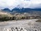 Airport runway in the mountain valley with the overcast weather snow mountain as background,