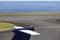 Airport runway near the ocean with aeroplane tale wing detail