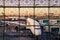 Airport terminal building windows during sunrise with an airplane outside at the gate for boarding of passengers. Burj Khalifa in