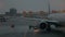 Airport view in the evening. Airplane and vehicles lights blinking