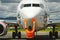 Airport worker directing airliner with paddles.