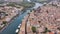 Airscape of French town Agde with view of tiled rooftops and river Herault.