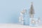 Airy elegance blue decoration and gift boxes, tree for christmas with silver ribbons on white wood background.