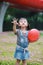 Aisa cute naughty lovely child girl with V pose play with balloon have fun outdoor in summer park happy smile happiness childhood