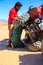 Ait Saoun, Morocco - February 22, 2016: Man trying to repair car in desert