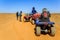 Ait Saoun, Morocco - February 23, 2016: Tourist on ATV in Ait Saoun Desert of Morocco wearing helmet for safety precautionary meas