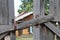 Ajar old gate made of wood with a wooden crossbar, close-up