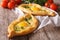 Ajarian khachapuri and fresh vegetables close-up. horizontal