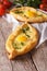 Ajarian khachapuri and fresh vegetables close-up. Vertical