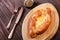 Ajarian Khachapuri traditional Georgian cheese pastry with eggs on cutting board.