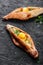 Ajarian Khachapuri traditional Georgian cheese pastry with eggs on dark wooden background