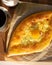 Ajarian traditional flatbread - khachapuri or hachapuri with egg and cheese.