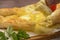 Ajarian traditional khachapuri with egg. Tomato and greens in the background.