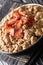 Ajdovi zganci Slovenian national dish of buckwheat flour and fried bacon close-up in a bowl. vertical