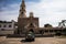 Ajijic, Jalisco, Mexico - January 15, 2021: Black hearse covered in flowers outside of a colonial church