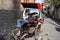 Ajmer, India - Jan 04, 2020: Sleeping rickshaw driver near the entrance gate of Dargah Shariff in Ajmer, India