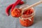 Ajvar in a jar with red chilli peppers