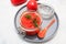 Ajvar, pepper mousse in a jar and on gray plate and gray backgground