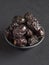 Ajwa Al-Madina dates are laid out on a black table