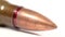 AK-47 ammunition 7,62x39mm, Defocus on a lying single bullet head. From the back to the front. White background