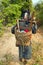 Akha villager carry things on her back in mountain, Laos