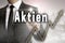 Aktien in german Shares is shown by businessman concept