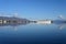 Akureyri, Iceland and surroundings reflected in calm water on sunny autumn day.